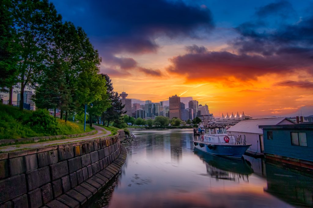 A boat on the shore of the lake and the beautiful golden sunset