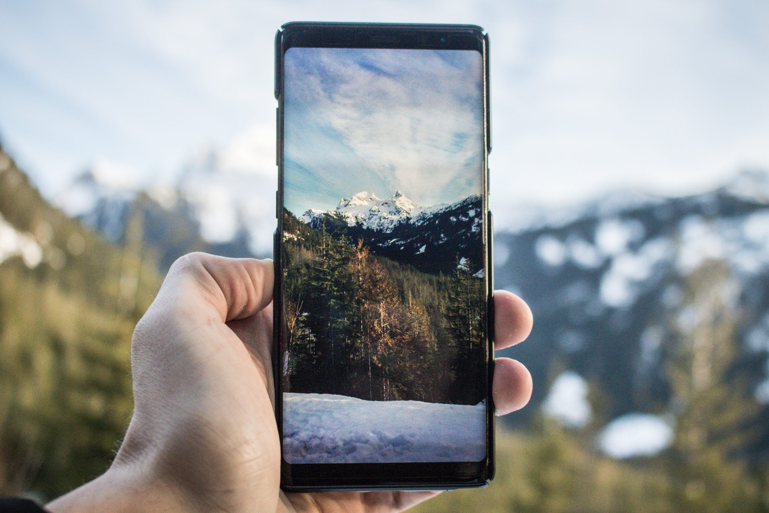 Beautiful mountains surrounded by snow from inside the phone scaled