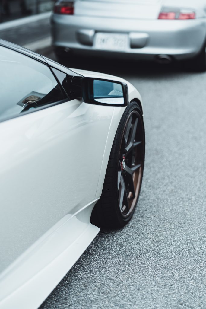 Close-up of a white sports car parked on the street