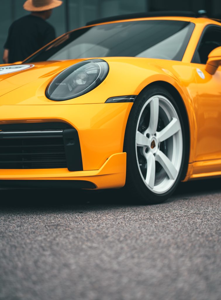 Yellow Porsche sports car on the street.