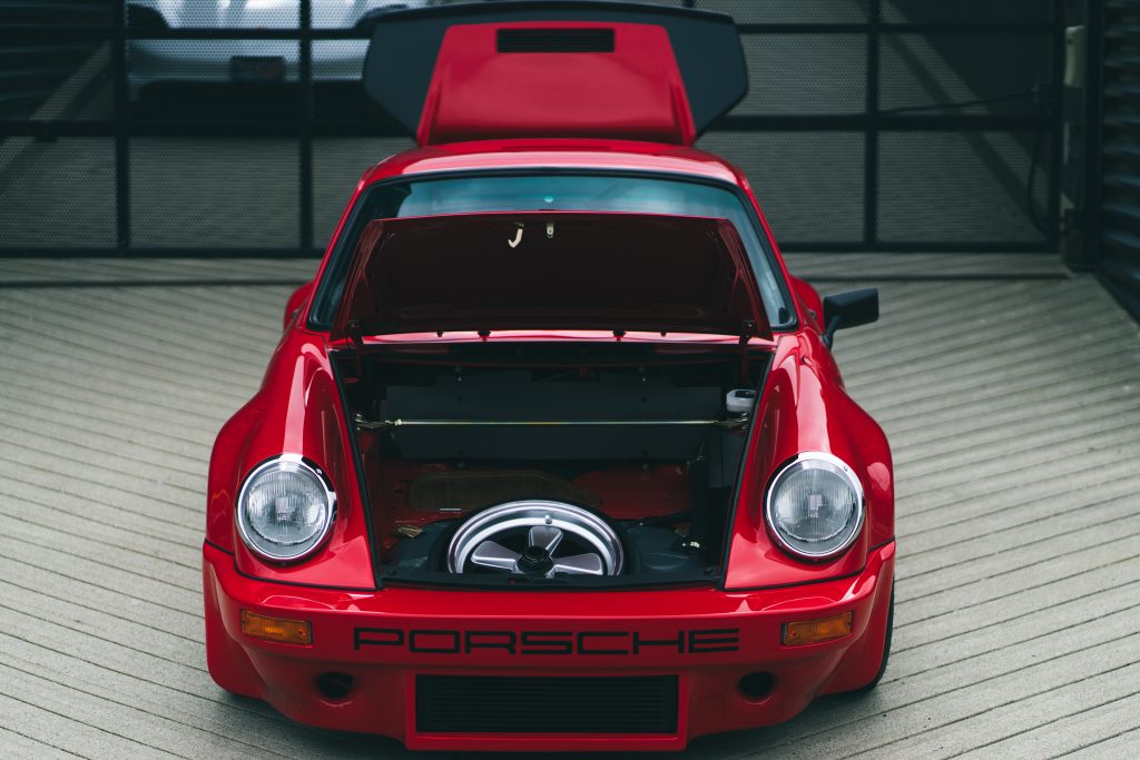 Red Porsche 911 Turbo S in the showroom.