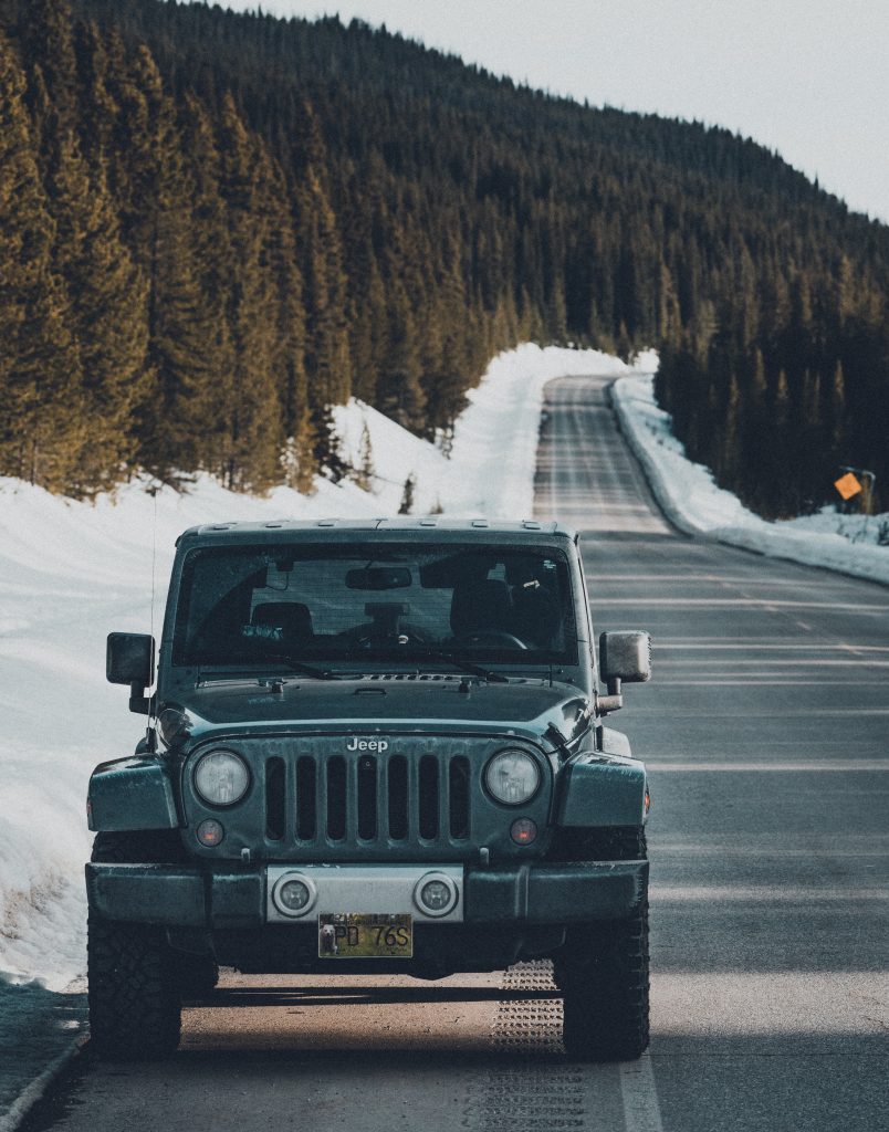 Black jeep wrangler on road