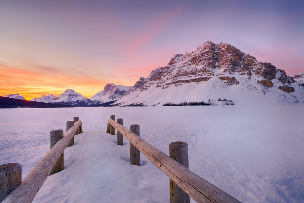 Bridge near mountain in snow on sunset