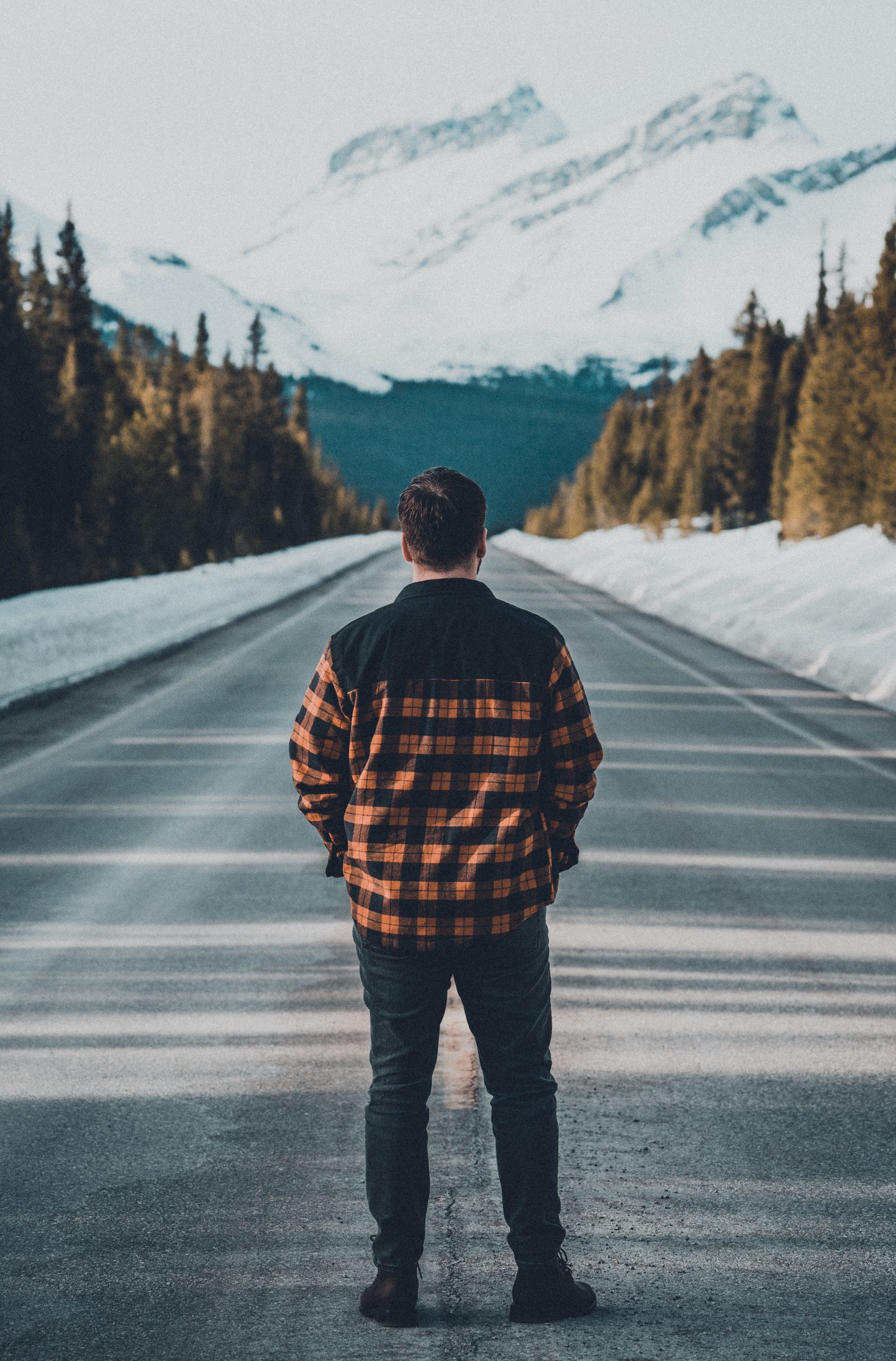 man in black and orange plaid jacket standing on road Royalty Free Stock Photo for Download