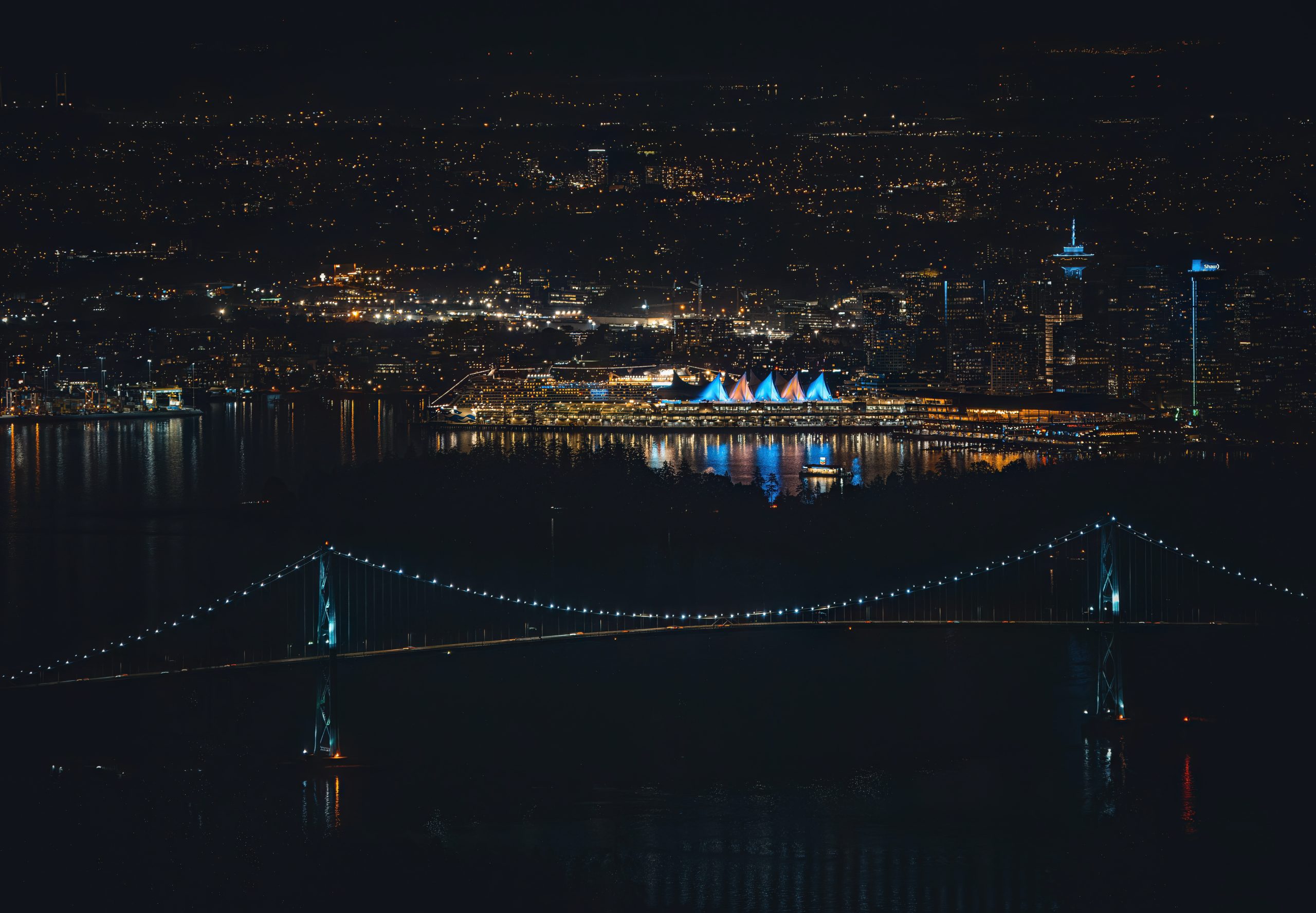 port city and bridge in lights at night scaled