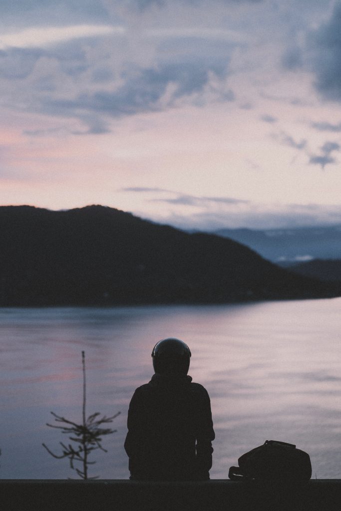 Silhouette of a person looking at a body of water