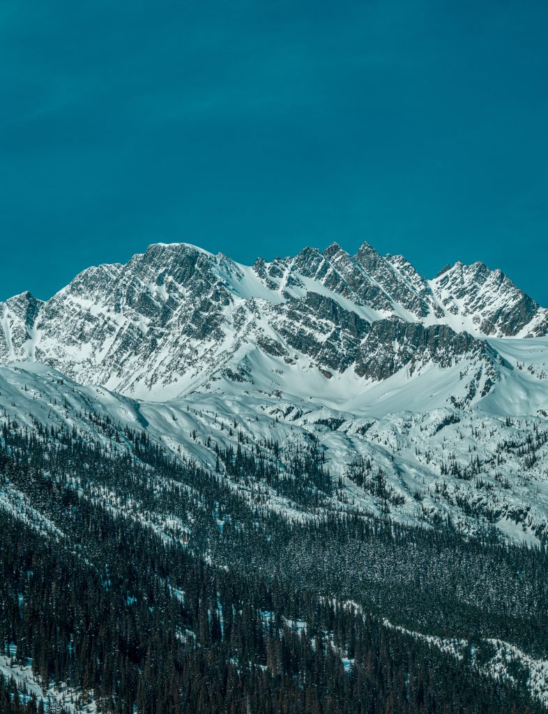 Snow covered mountain under blue sky