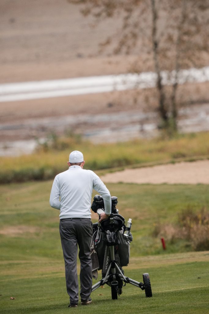 Golf player in action at the golf course during the tournament.