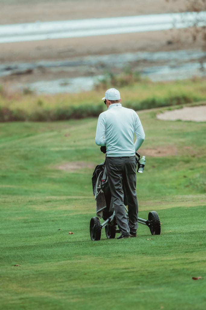 Golfer Walking on Golf Course with Bag